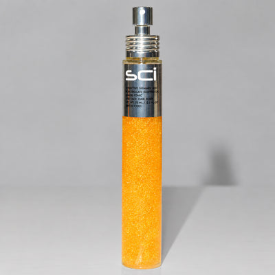 A clear cylindrical bottle filled with bright orange glitter hair color, topped with a silver spray nozzle and a black label reading SCI.