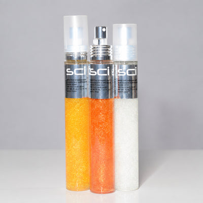 Three Sci Sci spray bottles filled with glittery shampoo, conditioner, and moisturizer, shown against a light gray background.